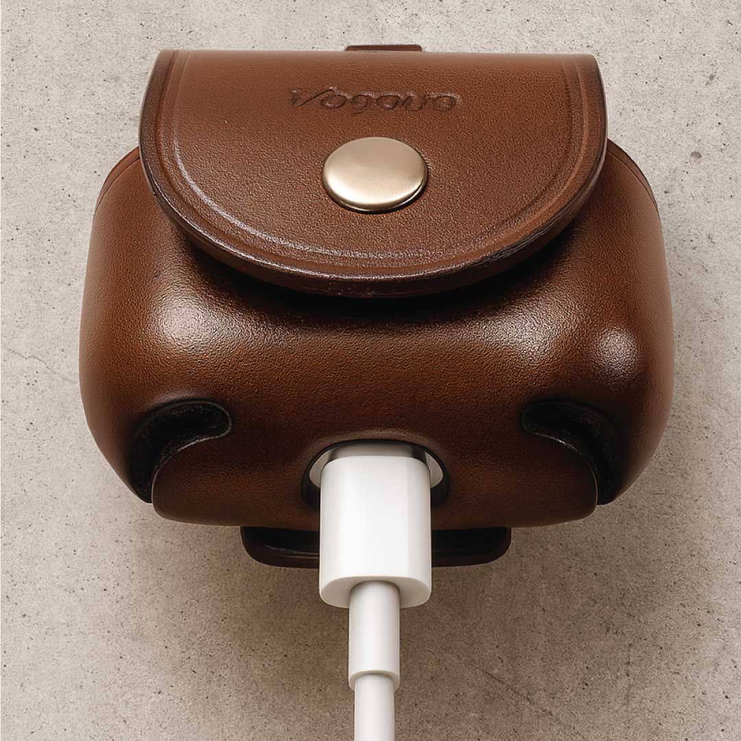 Brown leather case with a USB-C cable plugged in, charging.