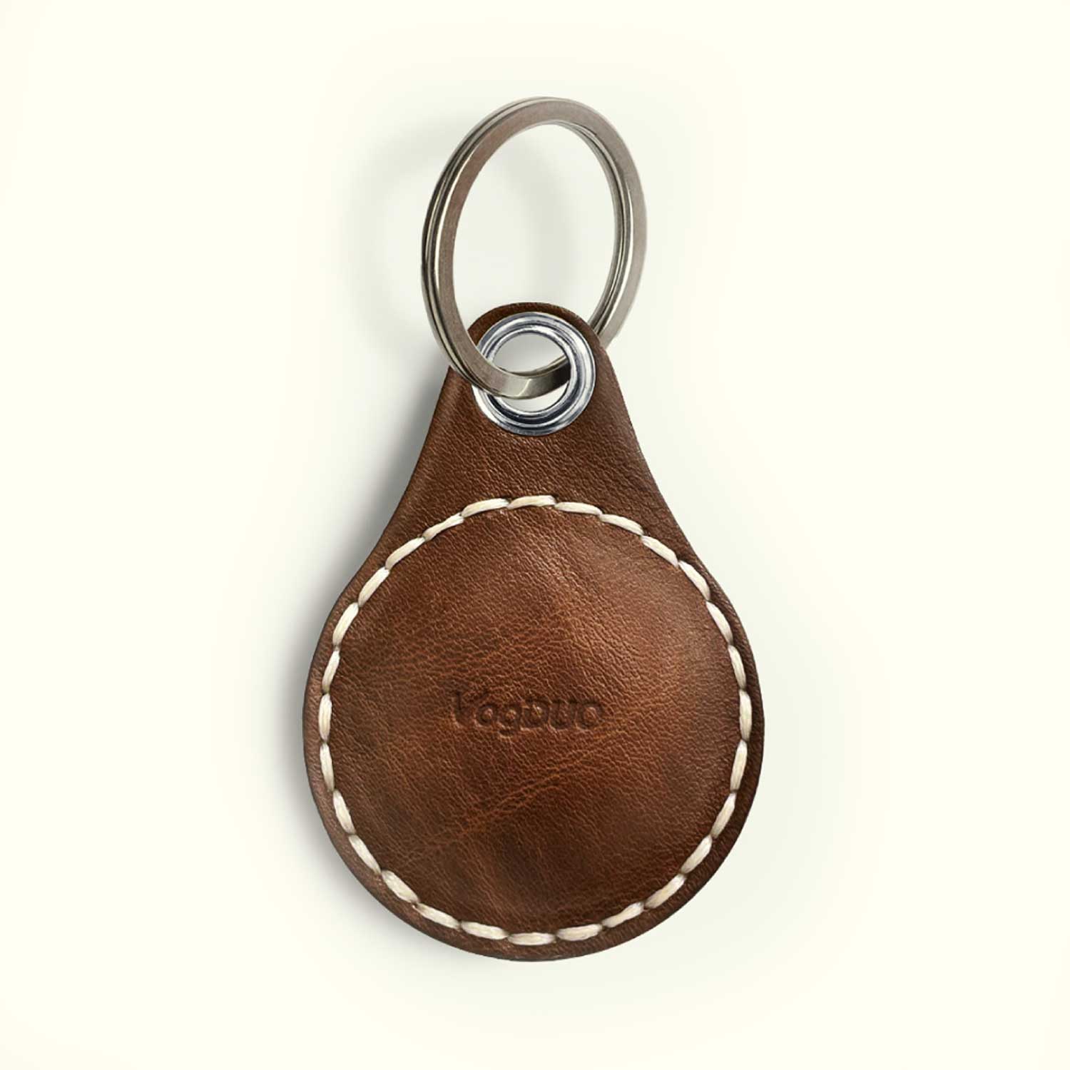 A brown leather key fob cover for AIrTag with white contrast stitching and an embossed 'VagDUO' logo, attached to a silver metal split ring.