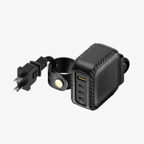 Black leather power adapter with USB ports and power extension cord with cable management on a white background