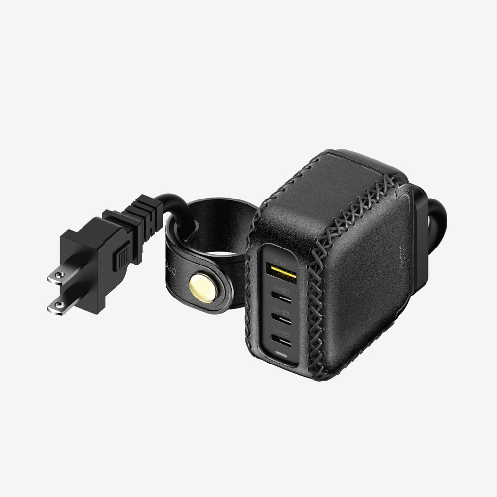 Black leather power adapter with USB ports and power extension cord with cable management on a white background