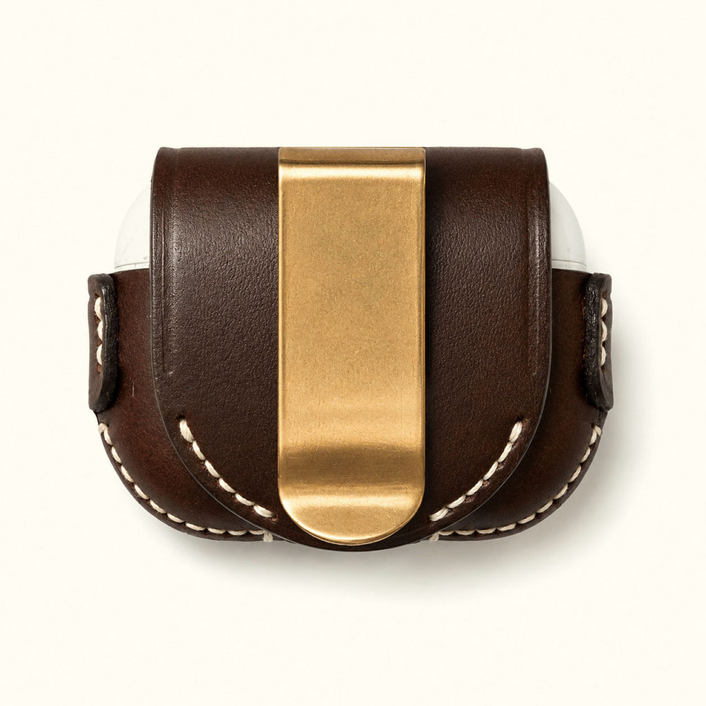 A dark brown leather pouch with a prominent brushed brass Belt Clip, white contrast stitching, and a white interior lining, shown against a plain off-white background.
