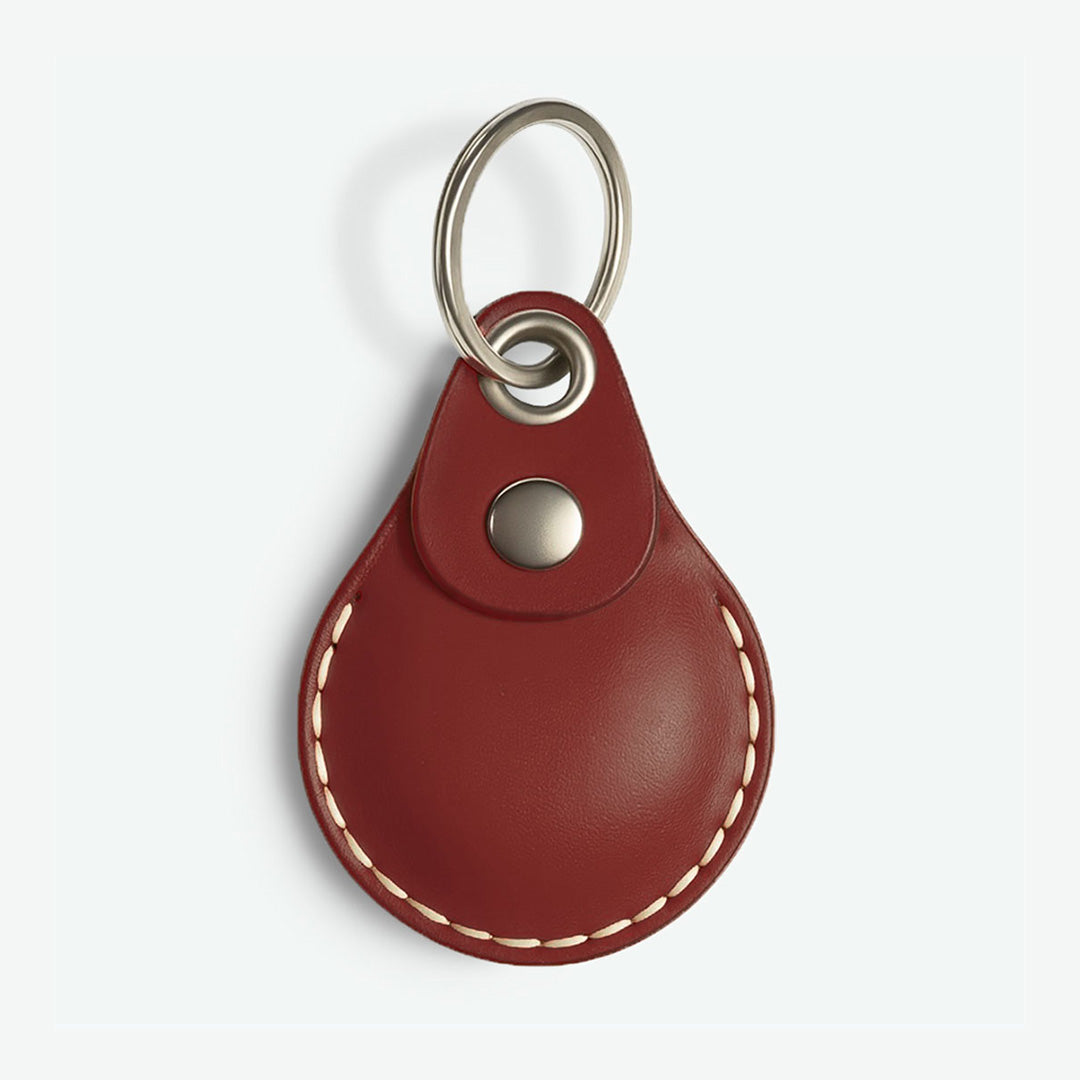 Wine Red AirTag leather keychain with metal ring on a white background