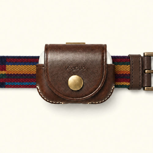A close-up of a VagDUO belt-clip Case for AirPods Pro 3. The center features a brown leather case with a brass snap button and debossed brand name, flanked by a woven multicolor belt strap with navy, red, yellow, and blue stripes on a light cream background.