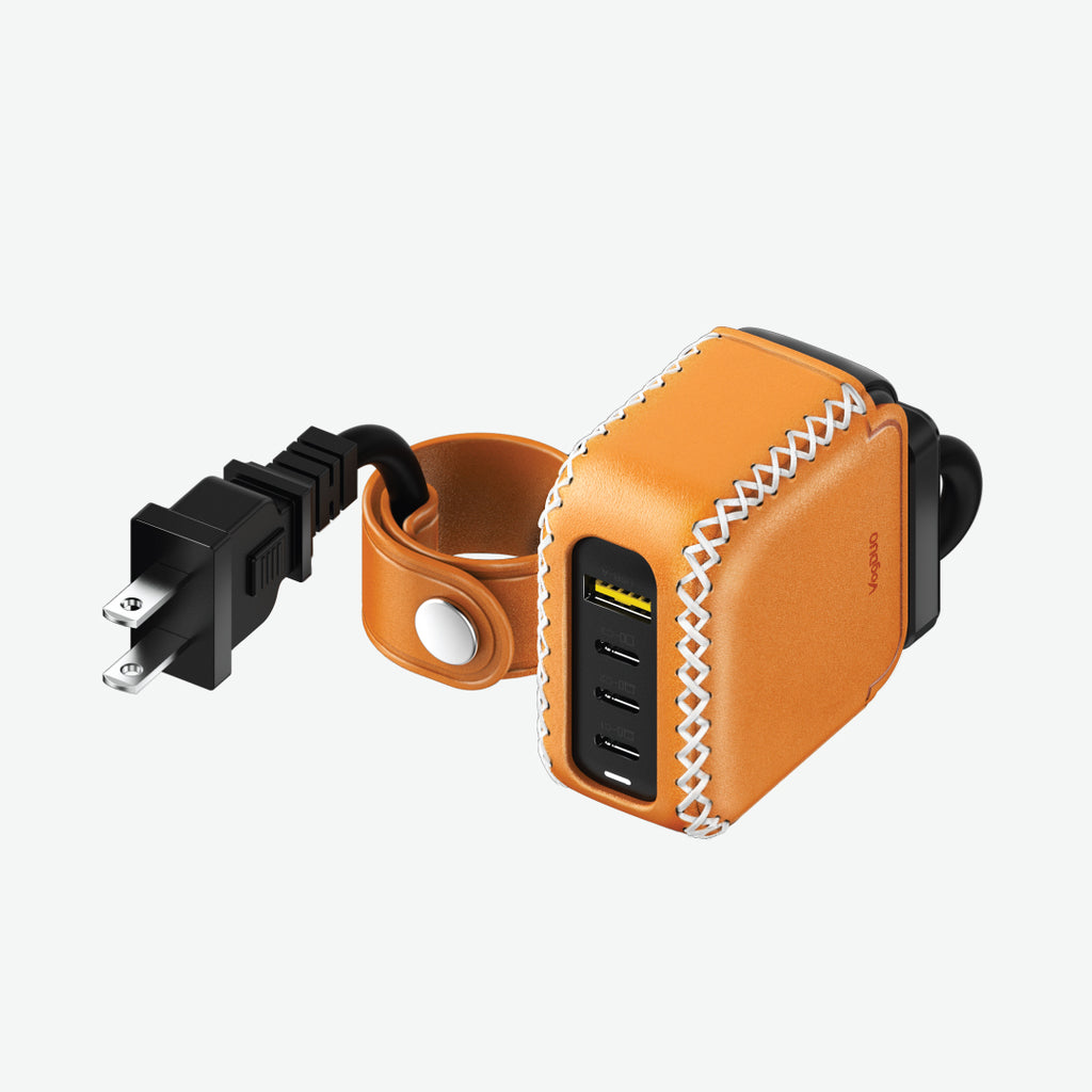 Tan leather power adapter with USB ports and power extension cord with cable management on a white background