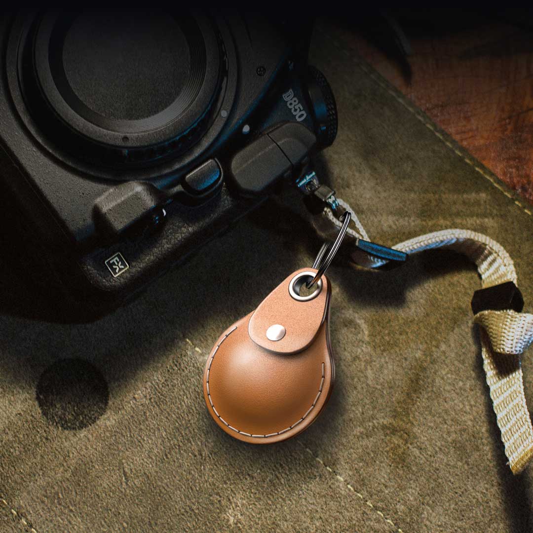 The AirTag leather case chained onto a camera neck lanyard