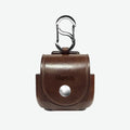 AirPods 4 Brown leather case with carabiner and gold accent on a white background