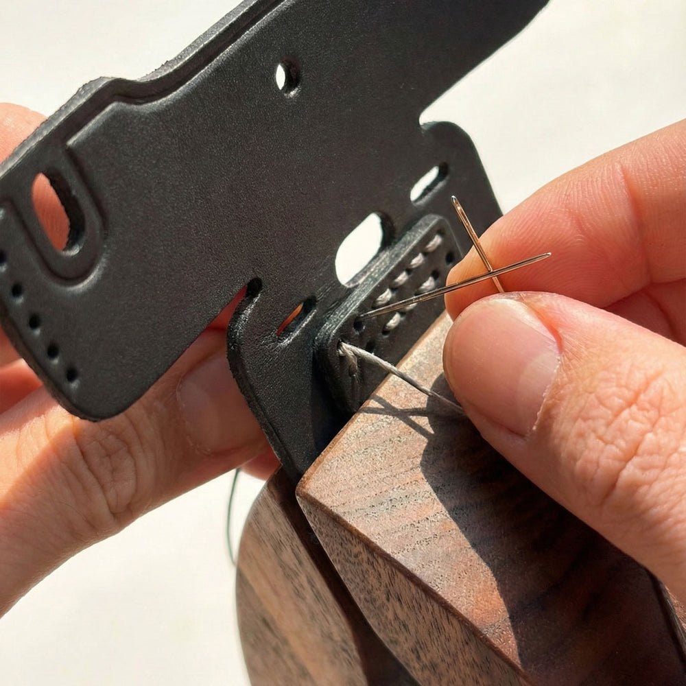 The craftsman performing the traditional saddle stitching.